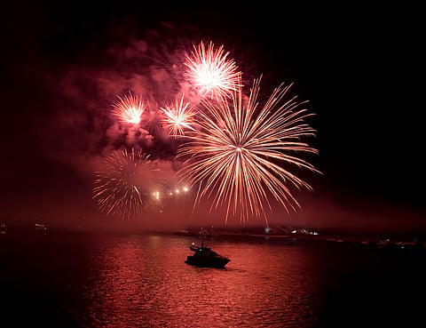 Fireworks display over a harbor 