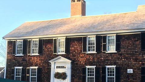 A picture of the18th century Jacobs Farmhouse, a two story shingled building with white trim.