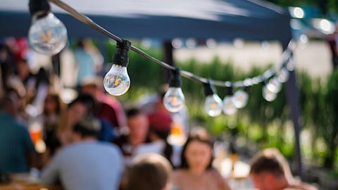 outdoor dining with string lights