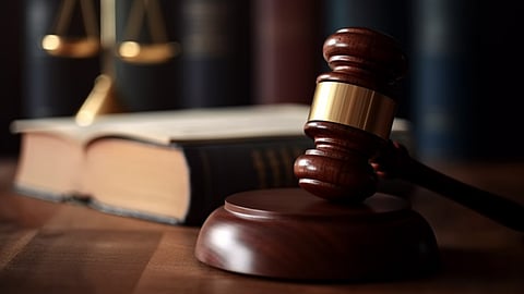 gavel on a desk with scales of justice and a book in the background