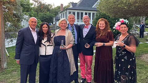 A group of partygoers poses outside