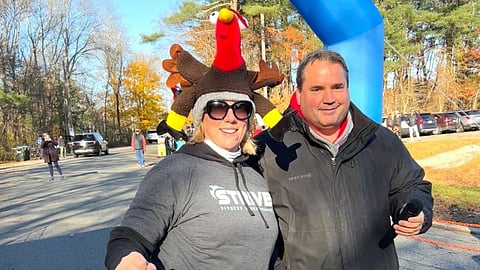Volunteers organize Norwell Middle School Turkey Trot runners at the starting line.