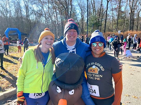 Volunteers organize Norwell Middle School Turkey Trot runners at the starting line.