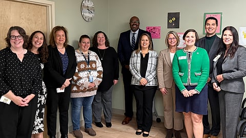 A group of elected and education officials stand together