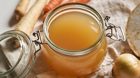 A jar of handcrafted bone broth representing the rich collagen, minerals, and slow-simmered comfort described in the article.