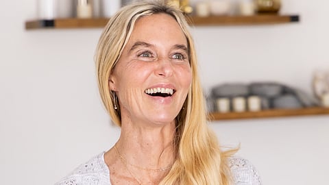 A blonde woman smiles in a store
