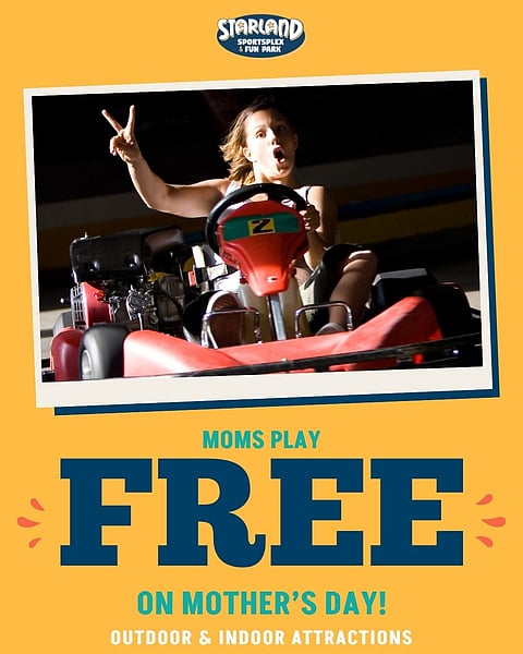 mom riding in a go kart throwing up a peace sign