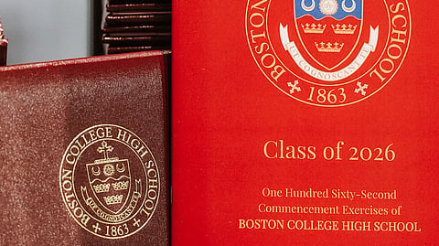 red diploma cover and red graduation 2026 program