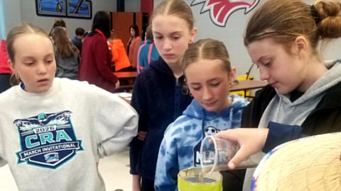 students experiment with water at a school science project