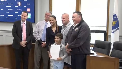 Nolan and Adam Gerbutavich receive a commendation from Marshfield officials for their actions during a May house fire.