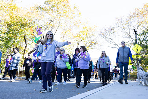 A photo of people bundled up in coats, walking alongside each other for the Walk to End Alzheimer's 