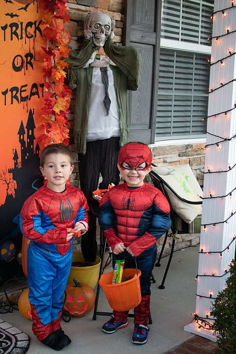Photo of two young boys dressed as superheroes