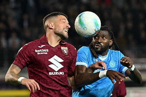 Torino's Cristiano Biraghi in action with Napoli's Frank Anguissa