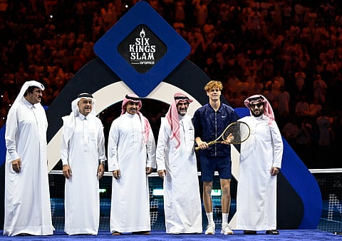 Jannik Sinner poses with a racket, Yasir Al-Rumayyan and the Chairman of Saudi Arabia's General Entertainment Authority, Turki Al-Sheikh