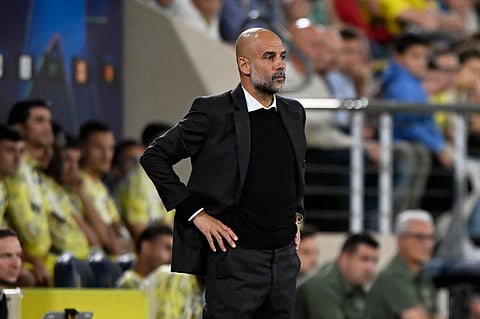 Manchester City manager Pep Guardiola looks on