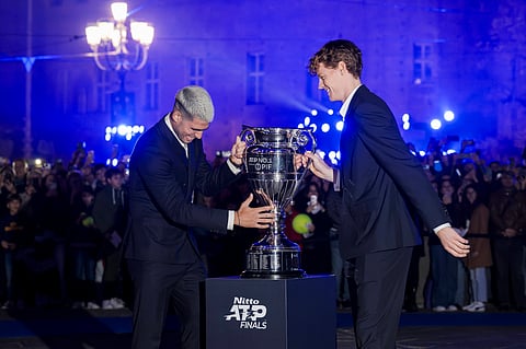 Jannik Sinner and Carlos Alcaraz pose with a trophy