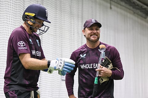 Brendon McCullum shares a laugh with Joe Root in the nets