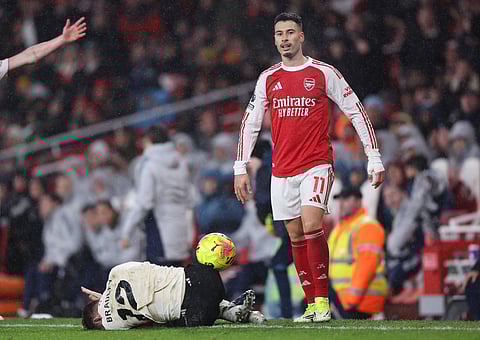 Gabriel Martinelli of Arsenal stands above an injured Conor Bradley ofLiverpool