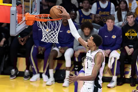 Victor Wembanyama attempts a dunk during an NBA game
