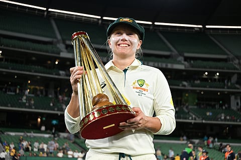 Alyssa Healy poses with the Ashes trophy