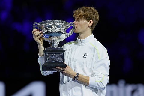 Jannik Sinner kisses the trophy after winning Australian Open 2025