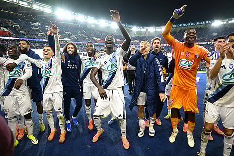 Paris FC players celebrate their win against PSG