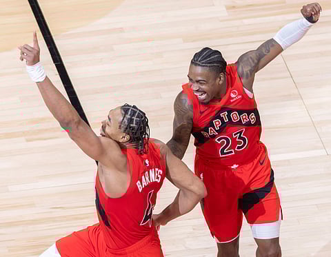 Scottie Barnes (L) and Jamal Shead of Toronto Raptors celebrate during an NBA game