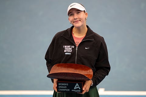 Mirra Andreeva poses with the trophy