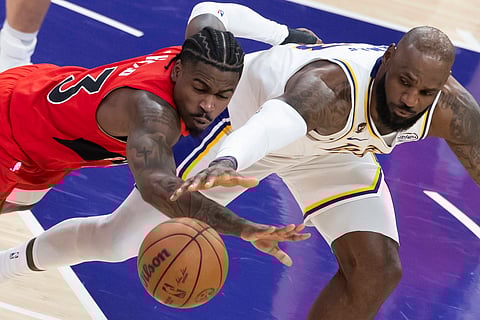 Los Angeles Lakers' LeBron James and Toronto Raptors' Jamal Shead in action