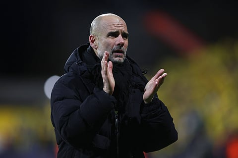 Pep Guardiola applauds the travelling fans at full time