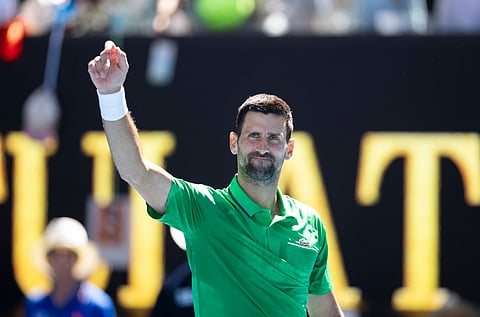 Novak Djokovic smiling on court after his win