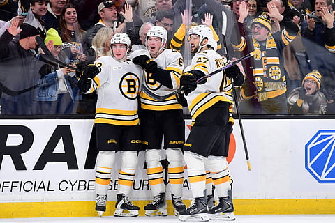Boston Bruins players celebrate after scoring