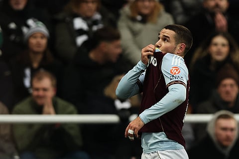 Emiliano Buendia kisses the badge after scoring against Newcastle United