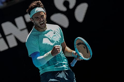 Lorenzo Musetti celebrates after beating Taylor Fritz