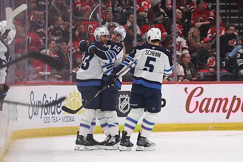 Winnipeg Jets players celebrate their goal against New Jersey Devils