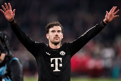 Leon Goretzka cheers with the Bayern Munich fans