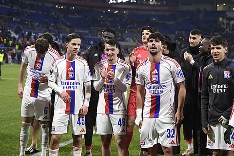 Lyon players celebrate after their win over PAOK FC