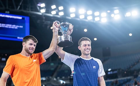 Neal Skupski and Christian Harrison hold the trophy