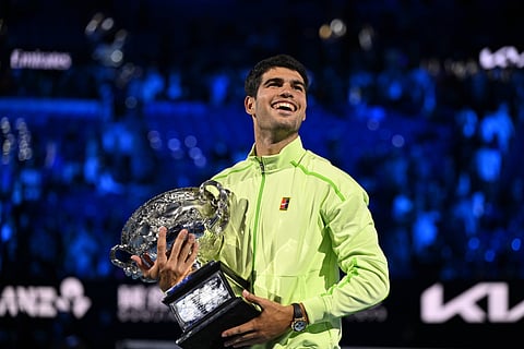 Carlos Alcaraz poses with the Australian Open title