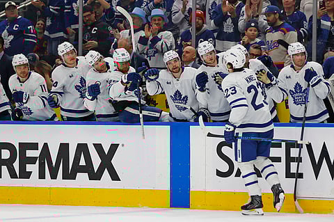 Toronto Maple Leafs players celebrate scoring a goal against Edmonton Oilers