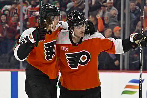 Jamie Drysdale celebrates his goal with Trevor Zegras
