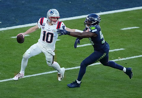 Drake Maye is pressured by Boye Mafe during the Super Bowl LX