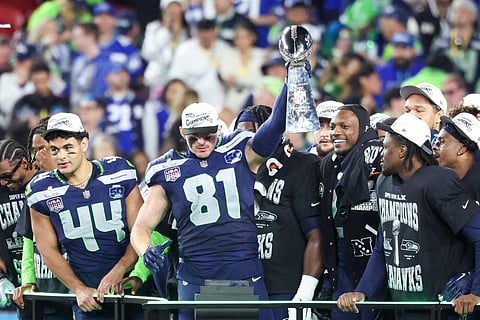 Seattle Seahawks players lift the Vince Lombardi Trophy