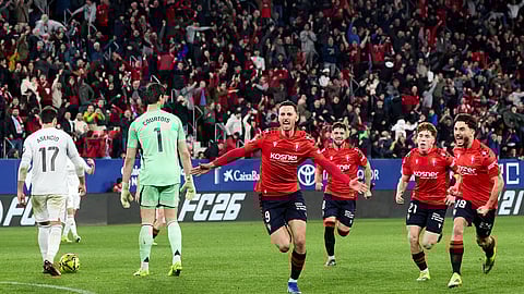 Osasuna players celebrate after scoring the winning goal against Real Madrid 