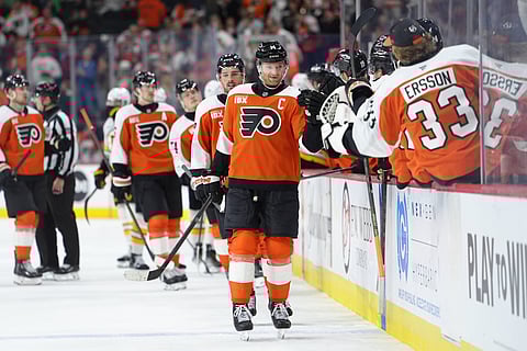 Philadelphia Flyers players celebrate after their goal against Boston Bruins