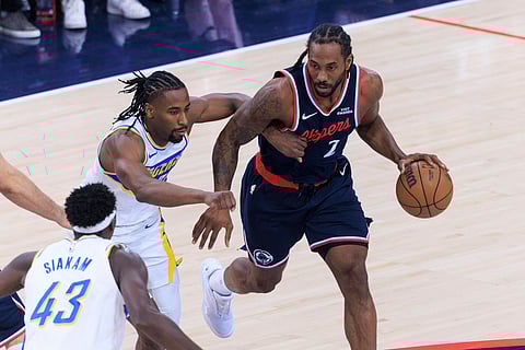 Kawhi Leonard drives past with the ball