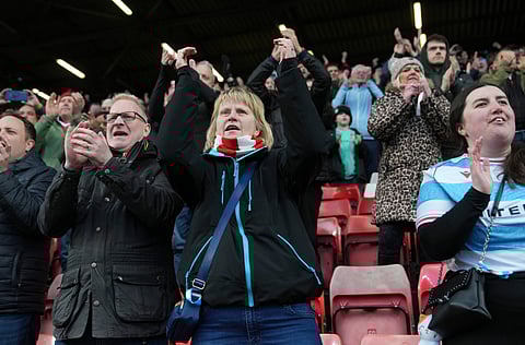 Wrexham fans applaud from the stands 