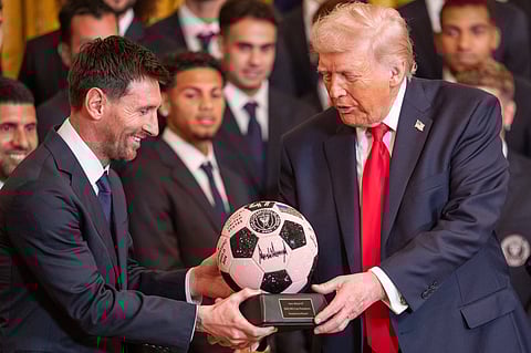 Lionel Messi presents a soccer ball to President Donald Trump