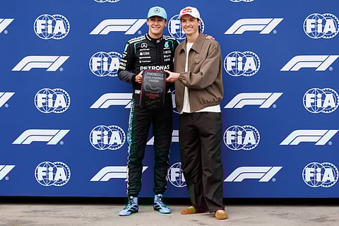 George Russell being presented with the pole position award