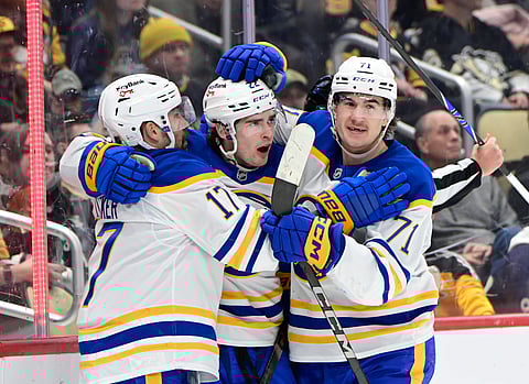 Buffalo Sabres players celebrate a goal 